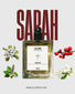 Perfume bottle labeled 'Sarah' by Olore with floral elements on a light background